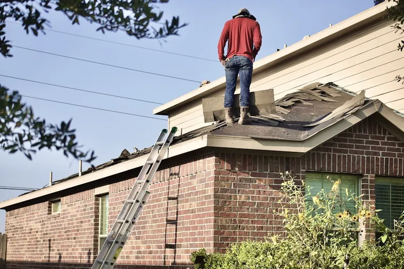 Professional roofer working on a residential roof in Crocketts